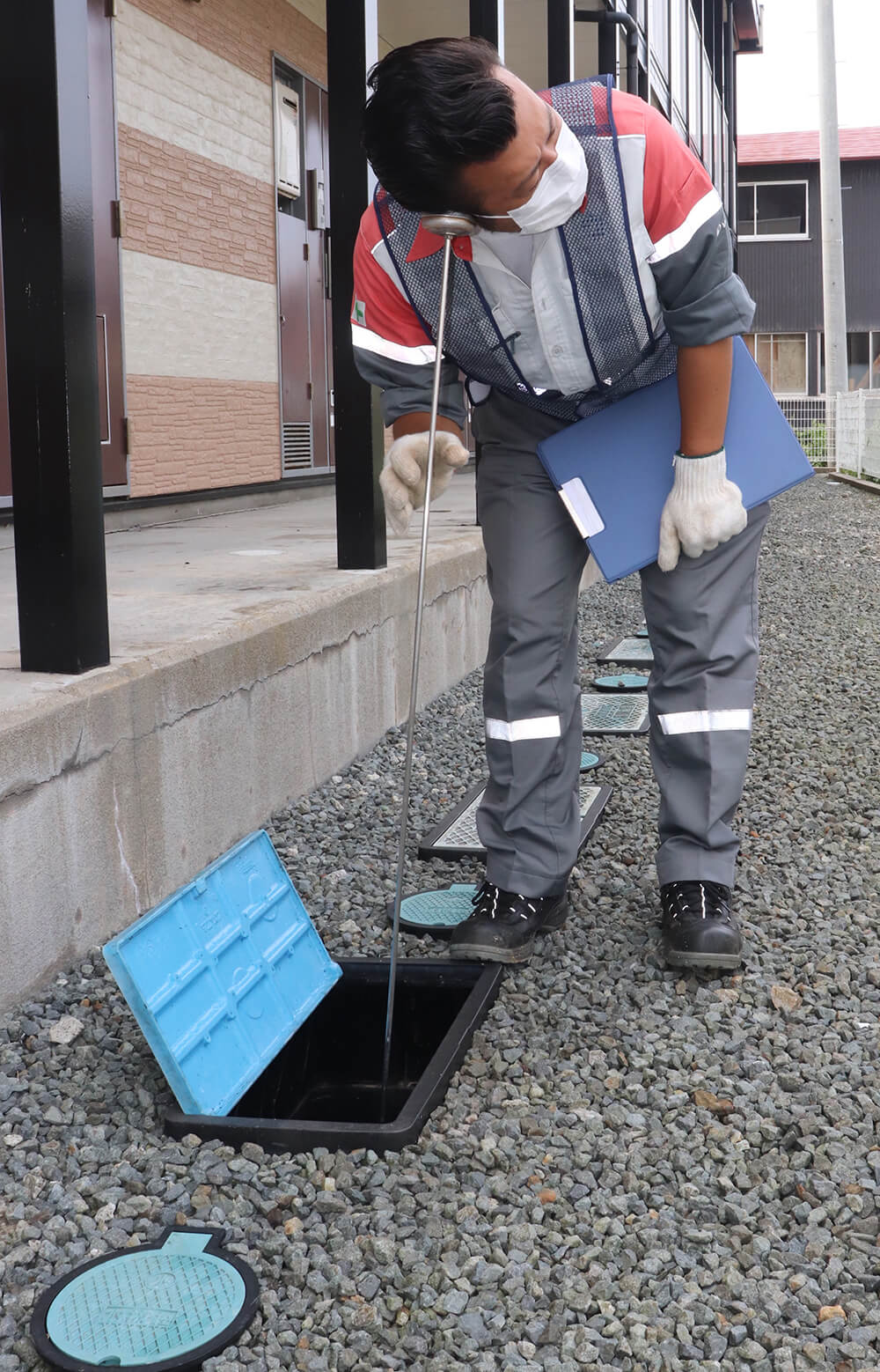 器具を使って漏水の有無を調べる担当者（能代市明治町で）